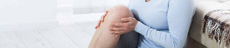 image of woman holding her knee