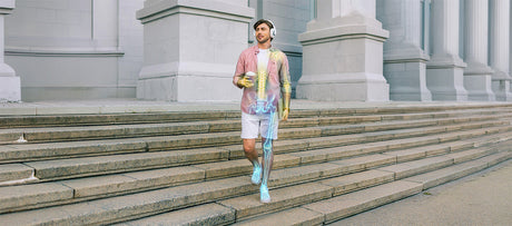 Man walking down outdoor steps, with an anatomy overlay showing the spine, pelvis, arm, and leg.