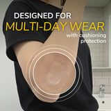 Cushioned waterproof bandage applied on upper arm over black shirt