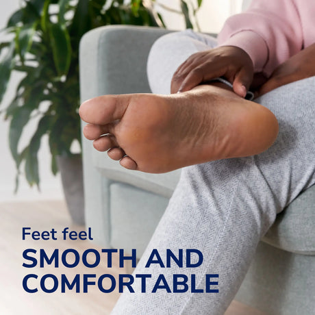 Electronic foot file held against bare heel on a seated leg